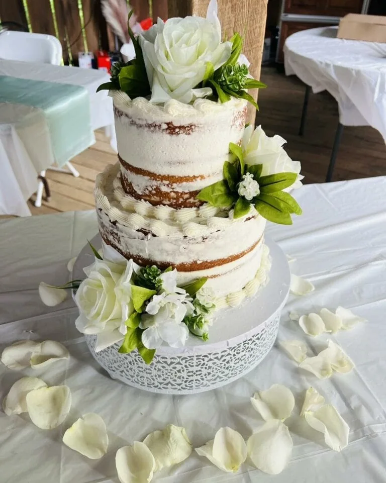 Cupcakes by Anna creates a wedding cake adorned with elegant white flowers.